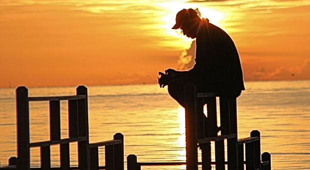 man-praying-sunrise-rgbstock